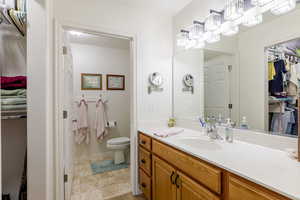 Full bathroom with a spacious closet and vanity
