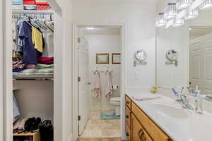 Full bath with vanity and a closet