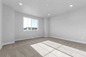 Unfurnished room featuring light colored carpet and recessed lighting