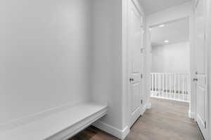 Mudroom featuring light wood-style flooring and recessed lighting