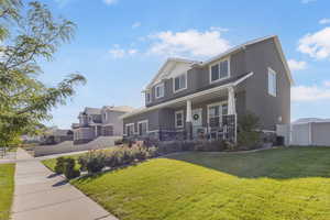View of front of property with covered porch, stone siding, stucco siding, and a residential view