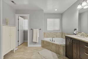Bathroom with a bath and vanity