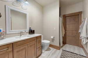 Full bathroom featuring vanity and light wood-style flooring