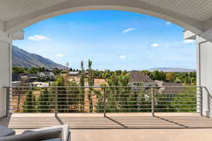 Balcony featuring a residential view and a mountain view