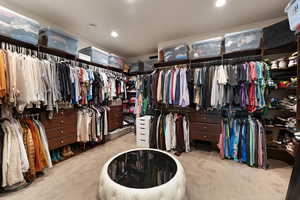 Spacious closet with light carpet