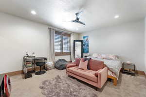 Bedroom featuring a textured ceiling, carpet floors, ceiling fan, and recessed lighting