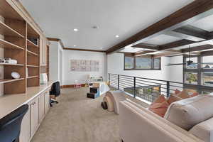 Sitting room featuring light colored carpet, built in desk, beam ceiling, recessed lighting, and a textured ceiling