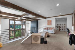 Carpeted living area with beamed ceiling, recessed lighting, and a textured ceiling