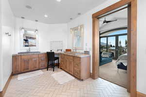 Ensuite bathroom with double vanity, a ceiling fan, and recessed lighting
