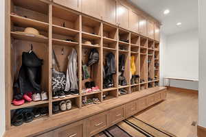 Mudroom featuring light wood-style flooring and recessed lighting