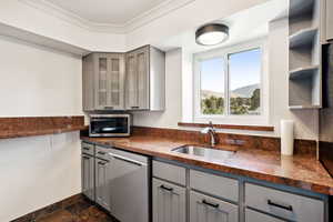 Kitchen featuring gray cabinetry, open shelves, a mountain view, and stainless steel appliances
