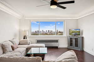 Living area with radiator heating unit and ceiling fan