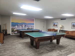 Game room with billiards & ping pong table.