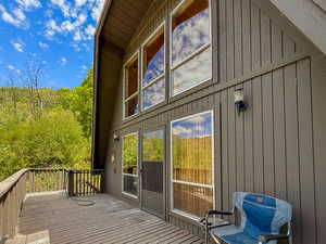 Entrance to property featuring a deck and board and batten siding