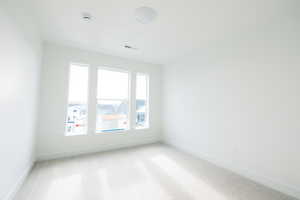 Carpeted empty room with baseboards