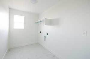 Laundry area featuring light marble finish flooring, hookup for an electric dryer, and hookup for a washing machine