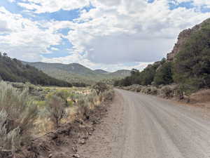 View of dirt / gravel road with a mountain view