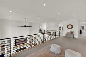 Corridor featuring an upstairs landing, recessed lighting, and carpet