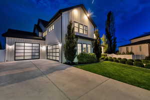 Modern farmhouse featuring driveway and board and batten siding