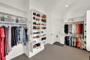 Spacious master closet with carpet and washer and dryer hook ups for the second laundry space in the home
