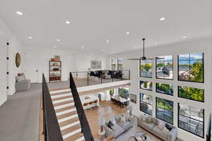 Carpeted loft area featuring recessed lighting and ceiling fan