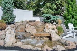 View of yard featuring a small pond