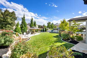 View of yard with a gazebo and a patio