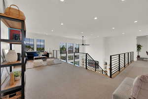 Hall with an upstairs landing and recessed lighting