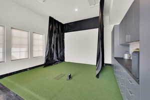 Golf simulator and custom wall shelving