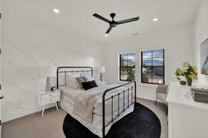 Bedroom with light carpet, recessed lighting, and a ceiling fan