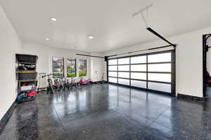 Garage with recessed lighting and baseboards