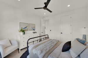 Carpeted bedroom with recessed lighting and a ceiling fan