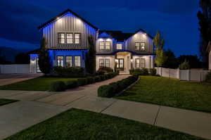 Modern farmhouse with board and batten siding and a gate