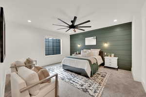 Carpeted bedroom with recessed lighting, a ceiling fan, and wood walls. Master Suite for Mother-in-law apartment in basement.