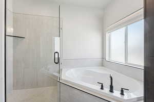 Full bathroom with a stall shower and a garden tub
