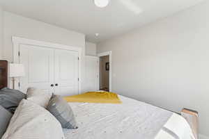 Bedroom featuring a ceiling fan and a closet