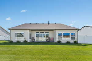Rear view of house featuring a patio, stucco siding, and a shingled roof