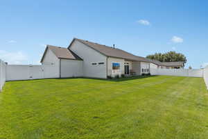 Rear view of property featuring a gate, a fenced backyard, a patio, and roof with shingles