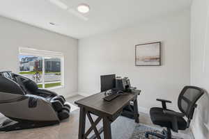 Home office featuring light colored carpet