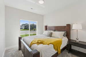 Carpeted bedroom with baseboards