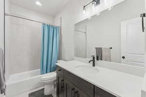 Bathroom with shower / bath combo, vanity, and recessed lighting