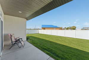Fenced backyard with a patio area