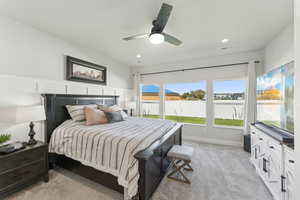 Bedroom featuring light colored carpet, a ceiling fan, and recessed lighting