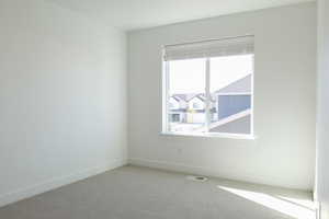 Empty room with baseboards and carpet