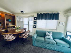 Dining area featuring lofted ceiling and ornamental molding