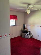 Recreation room with carpet flooring, a ceiling fan, and wallpapered walls