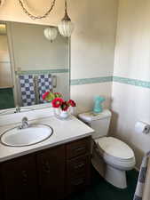 Half bath featuring vanity and toilet