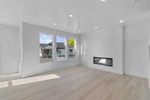 GREAT ROOM W/ FIREPLACE & LAMINATE FLOORS FOR NATURAL FLOW!  (PICTURE OF PREVIOUS BUILT HOME-COLORS AND MATERIALS MAY VARY)