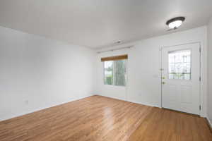 Entrance foyer with light wood finished floors and baseboards