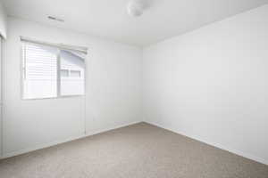 Carpeted spare room with baseboards